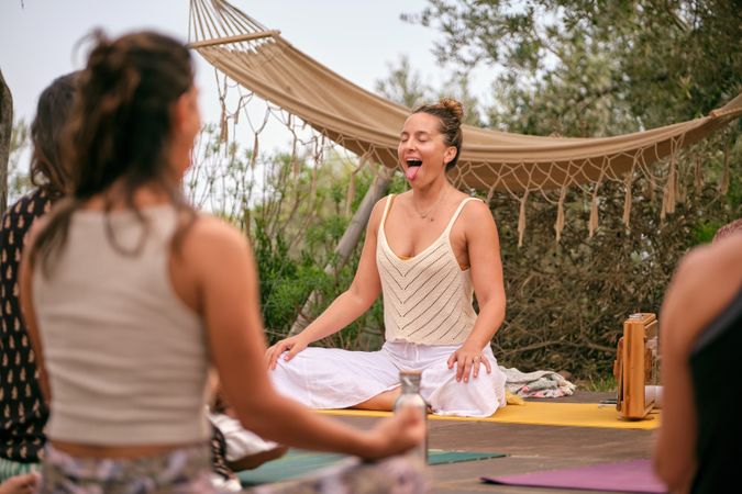 Group of women with instructor practicing yoga