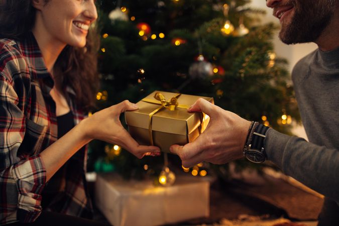 Happy couple celebrating Christmas together with gifts