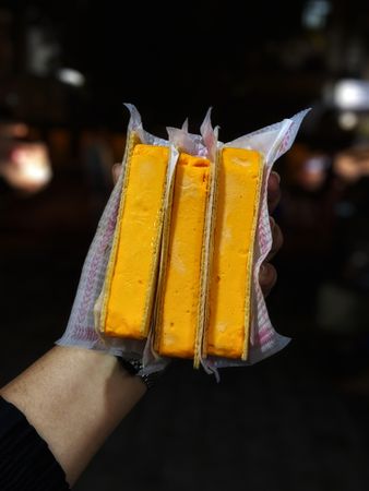 Person holding orange food