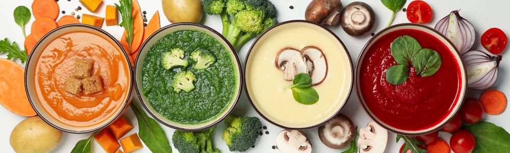 Wide shot of multi-colored vegetable soups