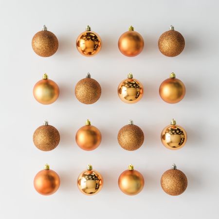 Golden Christmas baubles decoration on light background