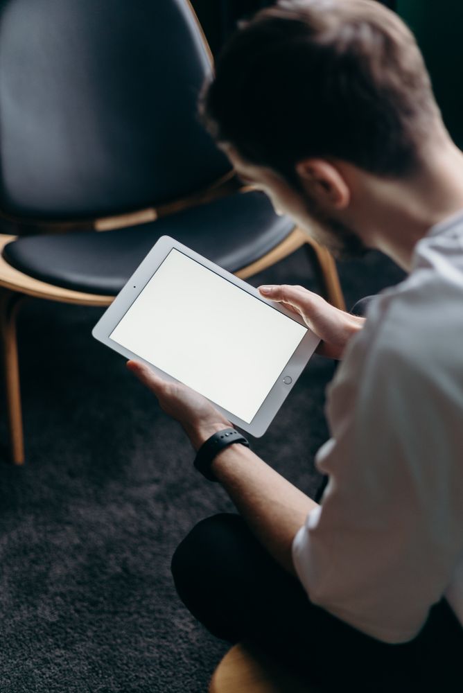 Back view of young man using tablet computer