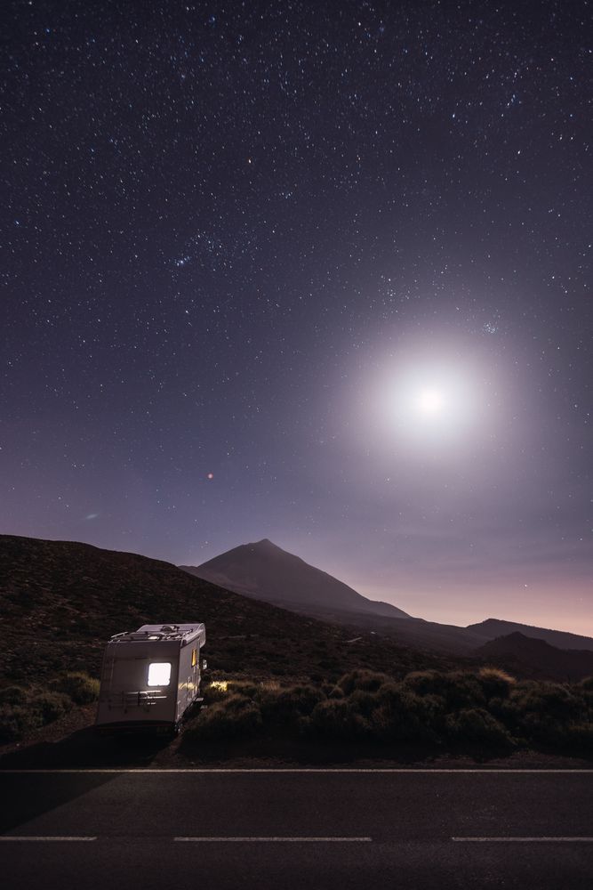Traveling caravan in desert with bright moon