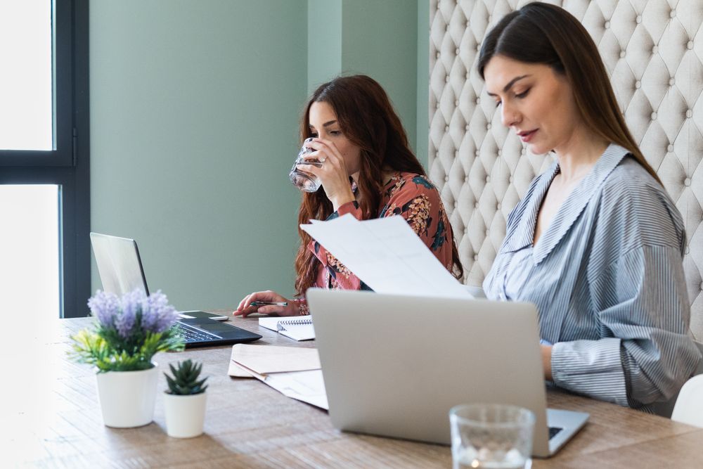 Focused women working on laptops in coworking space