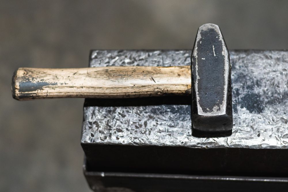 Hammer on workbench in blacksmith workshop