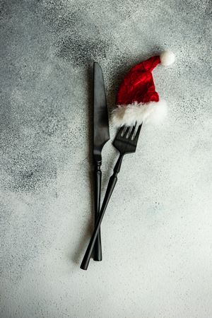 Christmas table setting with Santa hat on fork