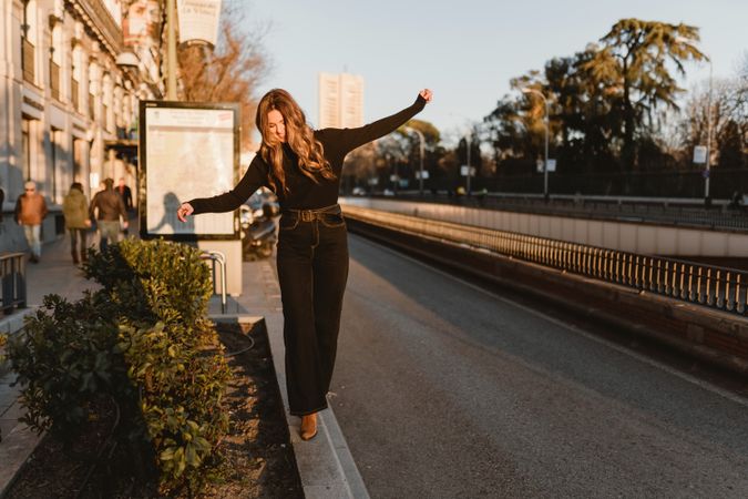 Stylish woman standing near metro station
