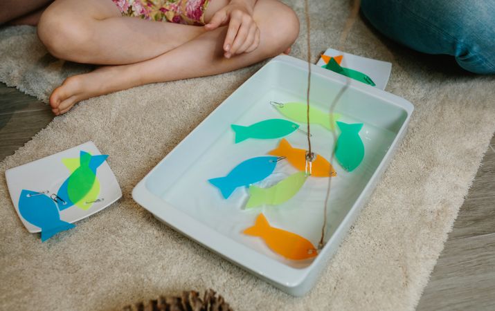 Homemade fishing game made with sticks and acetate