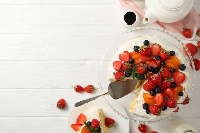 Composition with delicious berry cream cake on wooden table. Tasty dessert