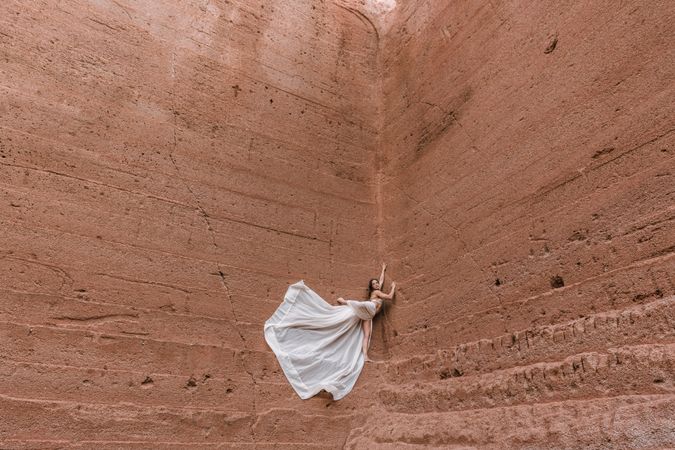 Elegant female posing on rocky cliff