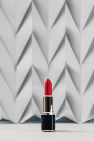 Pink lipstick on raised chevron. Product and make up contemporary concept