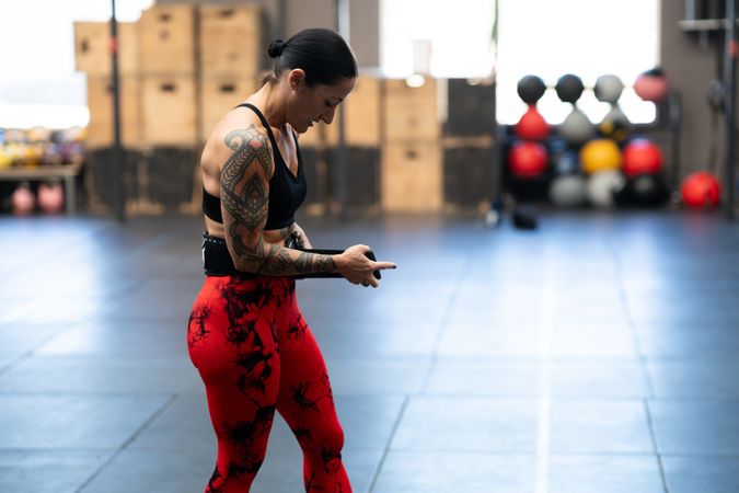 Strong woman attaching a belt to weightlifting