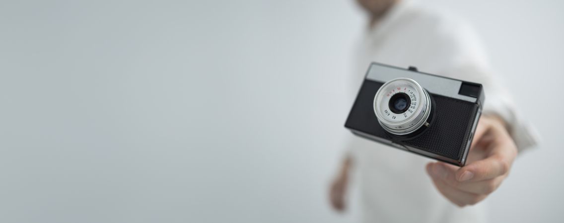 Retro camera floating in hand