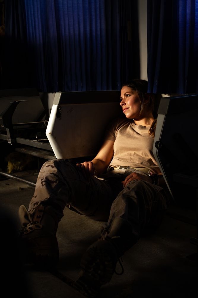 Female soldier on floor of military vehicle