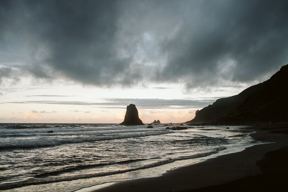 Lonely cliff in sea on cloudy day
