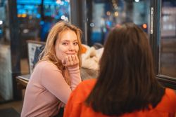 Multiethnic friends talking in cafe