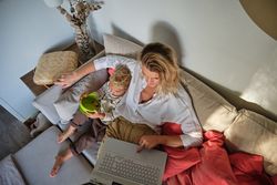 Mother and son browsing laptop at home