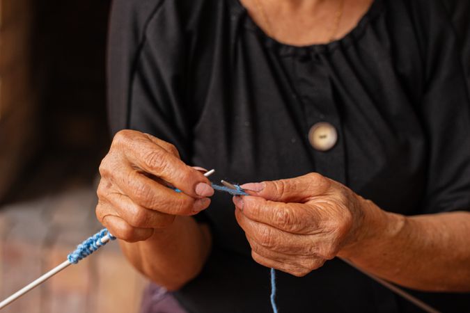 Older woman's artistic needlework.