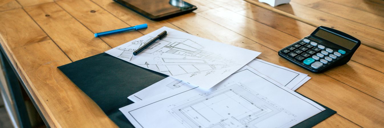 Workplace of an architect with blueprints and sketches