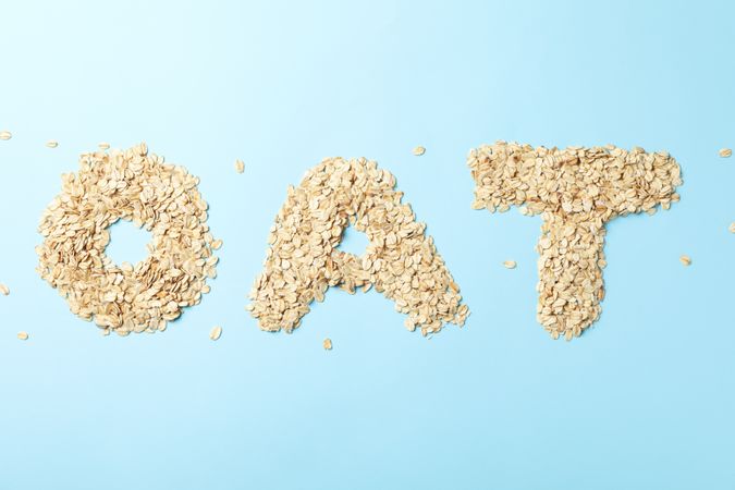Text Oat made of oatmeal flakes on blue background