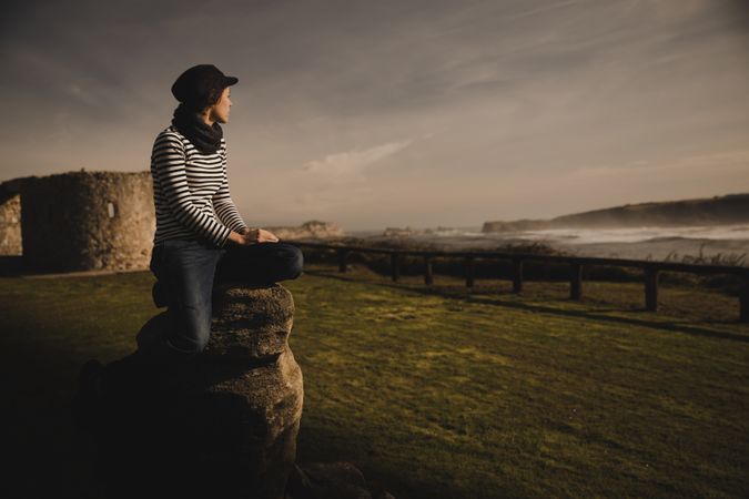 Woman and sitting on bench on shore near water