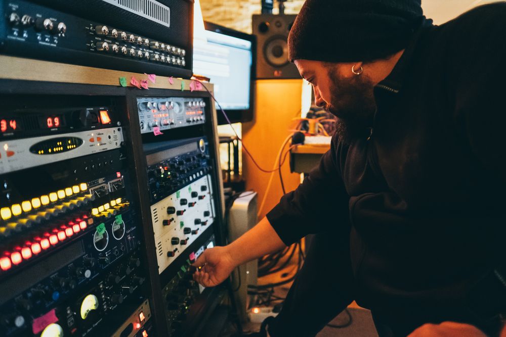Man adjusting sound control in a studio
