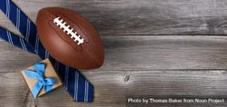 Father’s day celebration with American football and gifts on wooden background 5zLeXb