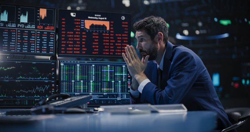 Financial Crisis Concept with Stock Broker Saddened by Negative Ticker Information, Red Graphs and Real-Time Data