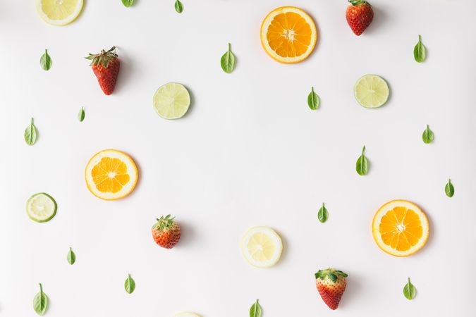 Colorful pattern made of citrus fruits, leaves and strawberries