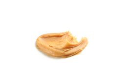Creamy peanut butter isolated on light background. A traditional product of American cuisine