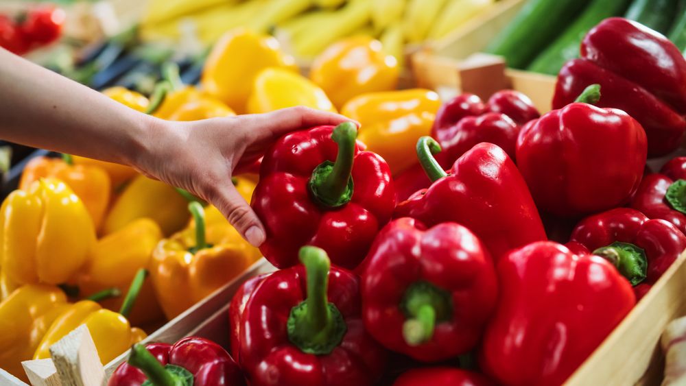 Woman Buying Fresh Vegetables from a Local Farm Market Stall.