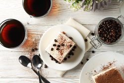 Composition with tasty tiramisu on wooden background. Delicious dessert