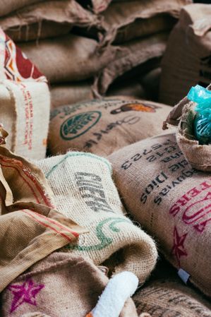 Stacked bags filled with coffee beans in warehouse