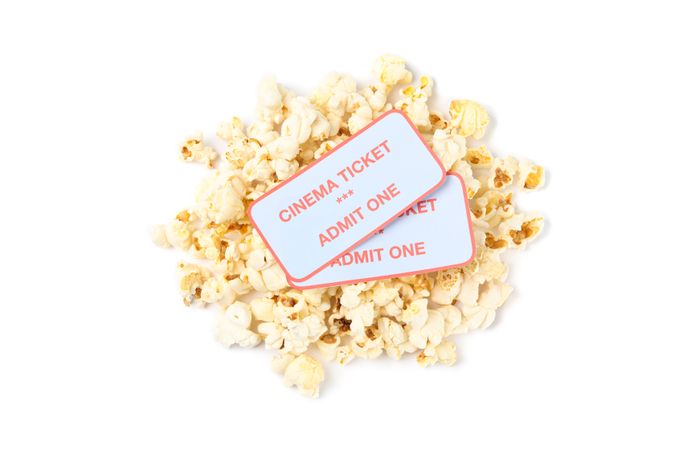 Popcorn pile with tickets isolated on blank background, top view