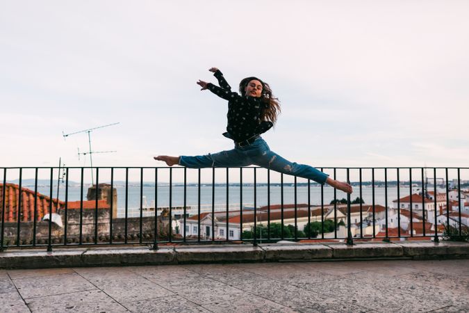 dancer jumping against cityscape