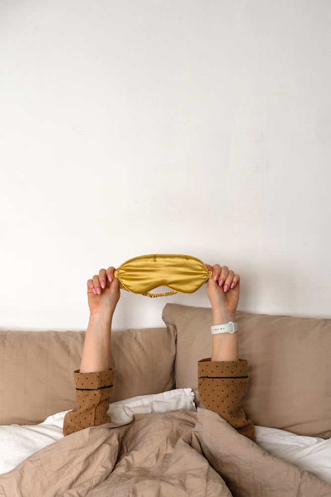 Hands up with sleep mask and smartwatch