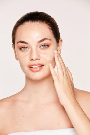 Amiable female taking care of face