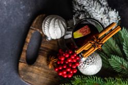Top view of mulled wine on bread board with Christmas decorations