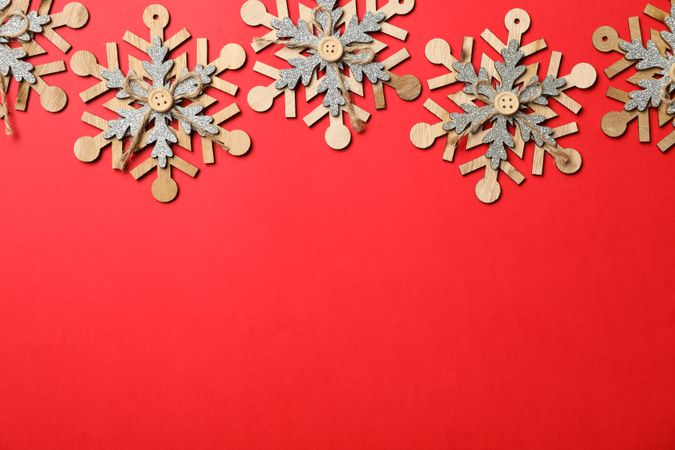 Decorative snowflakes on red background, space for text