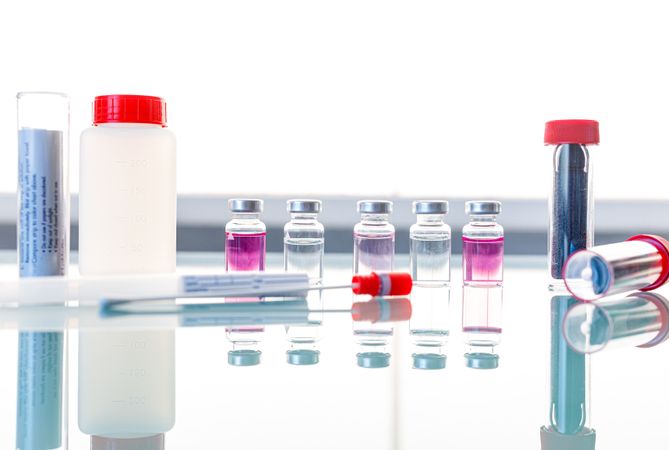 Sterile tubes and medical samples on glass table