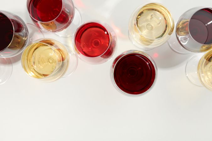 Flat lay composition. Glasses with different wine on plain background, top view