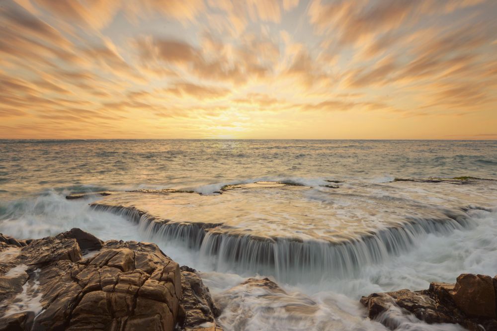 Time lapse photography of wave crashing during sunset