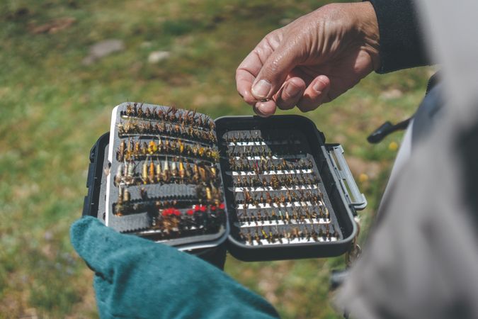 Fisherman demonstrating collection of baiting in box