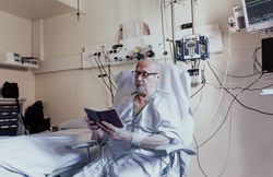 Older man admitted to a hospital room.