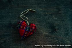 Valentine's day concept of tartan heart decorations on wooden table with space for text bYqqPX
