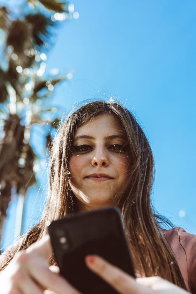 Teen girl looking at her smartphone.