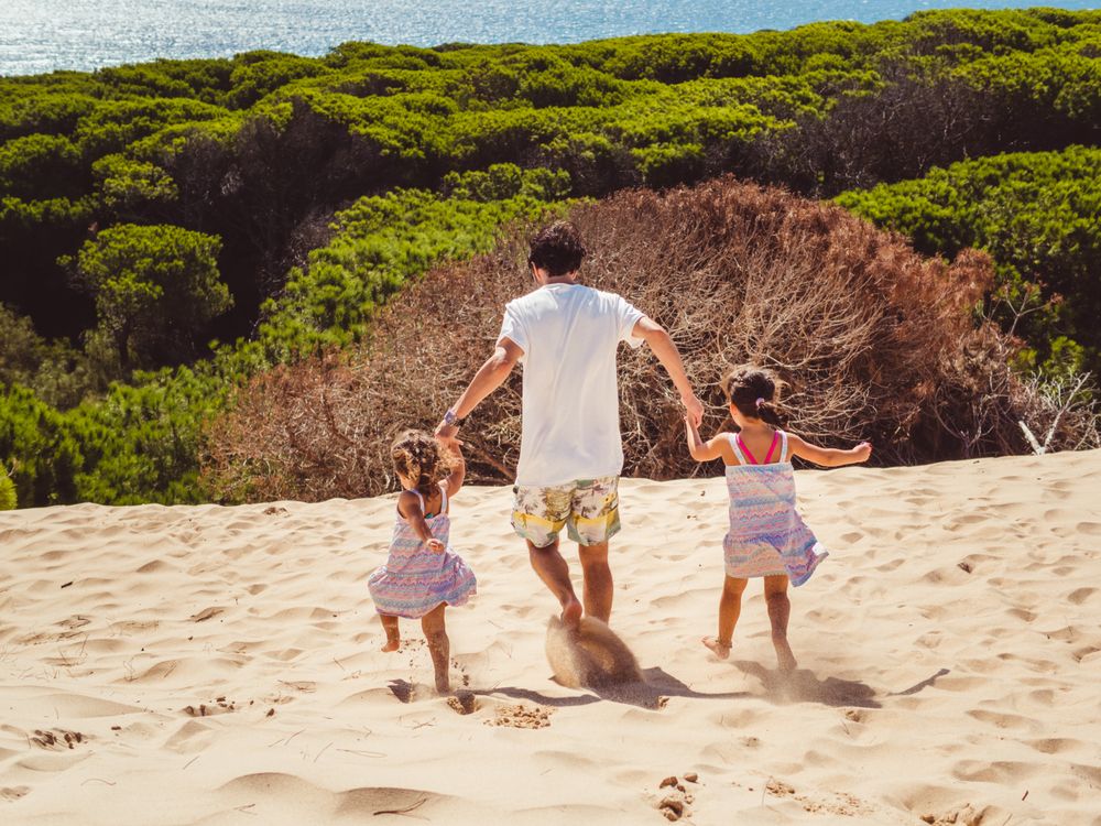 Anonymous family walking in the beach