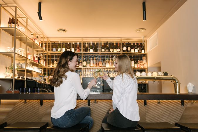 Cheerful women drinking cocktails in bar