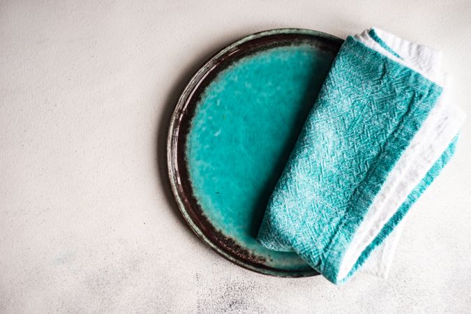 Top view of ceramic teal plate with matching napkin