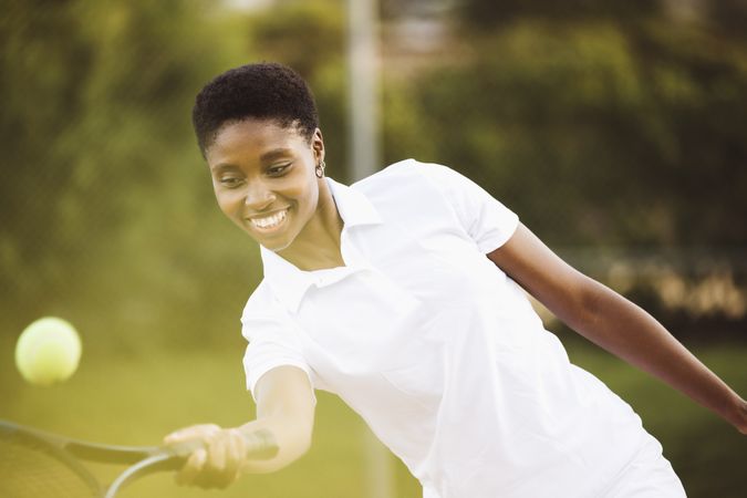 Young woman playing tennis match
